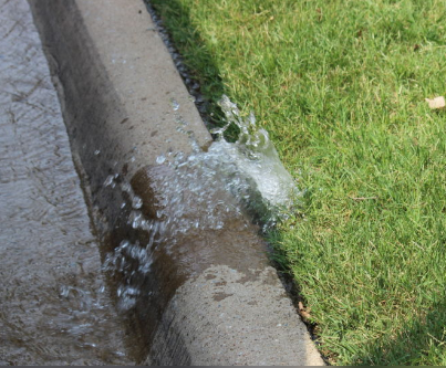 Broken sprinkler gushing water